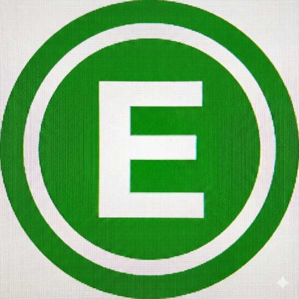 Panoramic view of Dominica's lush rainforest canopy with mist-covered mountains and waterfall in distance